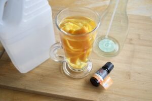 vinegar, extracted orange peel in a glass with essential oilsDIY All Natural All Purpose Cleaner
