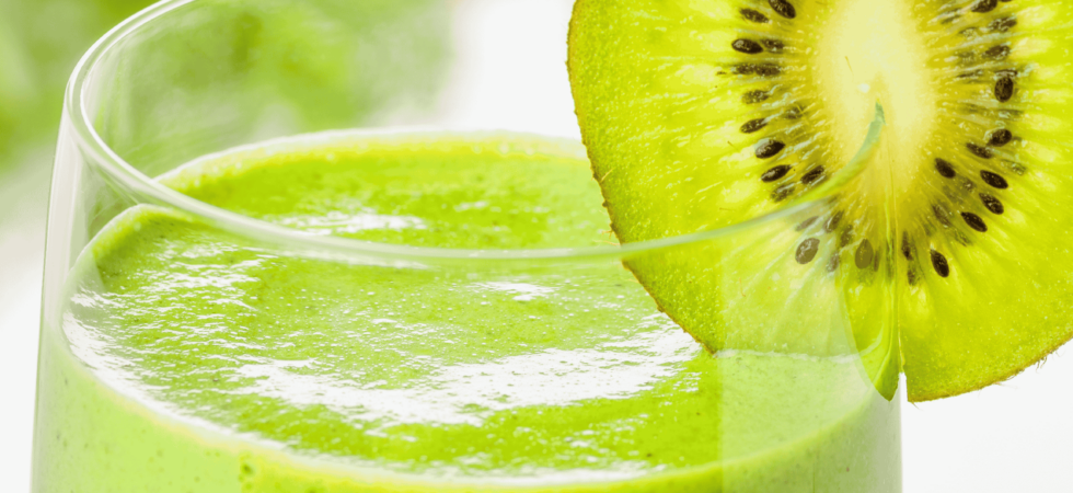 Glass of green smoothie with Kiwi