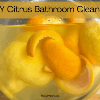 Glass jar filled with orange and lemon peels for a citrus bathroom cleaner